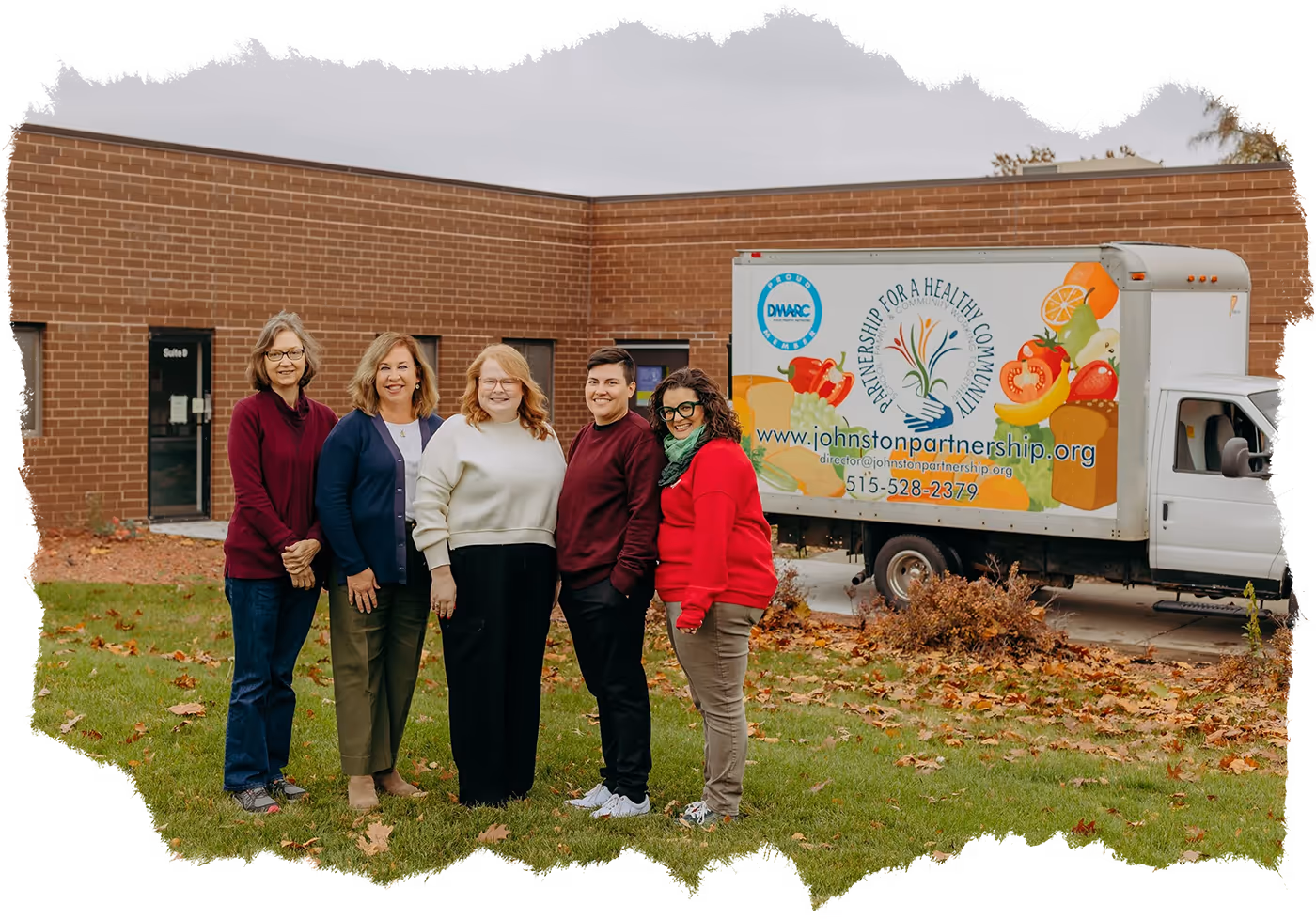 Group of workers from Johnston Partnership standing in front of the food delivery truck