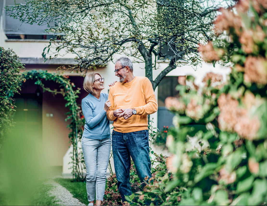 retired couple smiling in garden