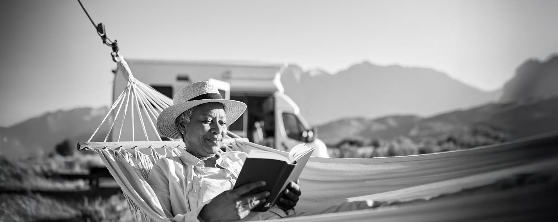 Retired Woman Reading Book in Hammock