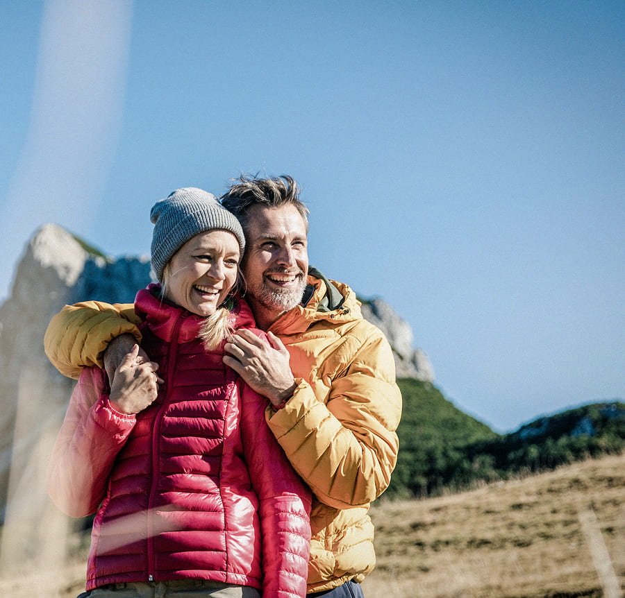 Retired couple taking a walk through the mountains