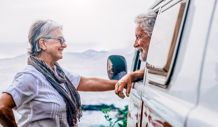 Retired Couple on a vacation in a antique Volkswagen van
