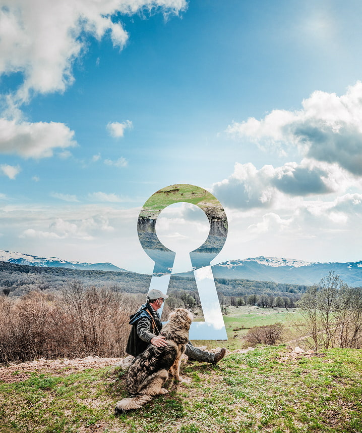 BOSS Retirement keyhole in the background of a man and dog resting on a hike