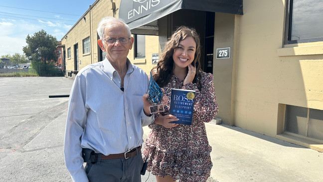 CBS2's Sophia Doumani presents upholsterer Garry Field with the B.O.S.S. Retirement Solutions Silver Award