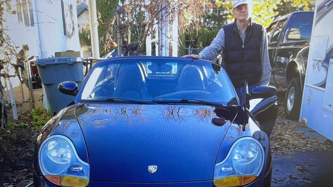 Field posing with a piece of his car collection