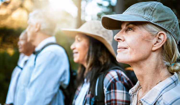 Retirees on a morning hike through a forest