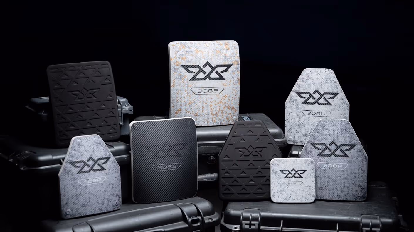 Various shapes and sizes of ballistic plates labeled 308E, 308B, and 308P on cases.