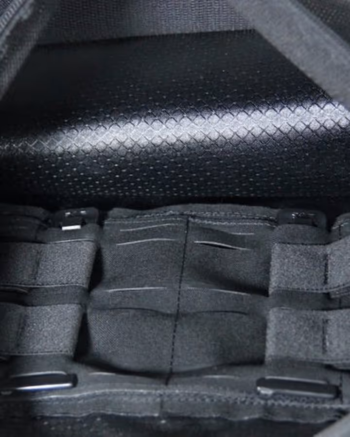 Interior of a black bag showing multiple sewn-in elastic straps and compartments for organizing items.