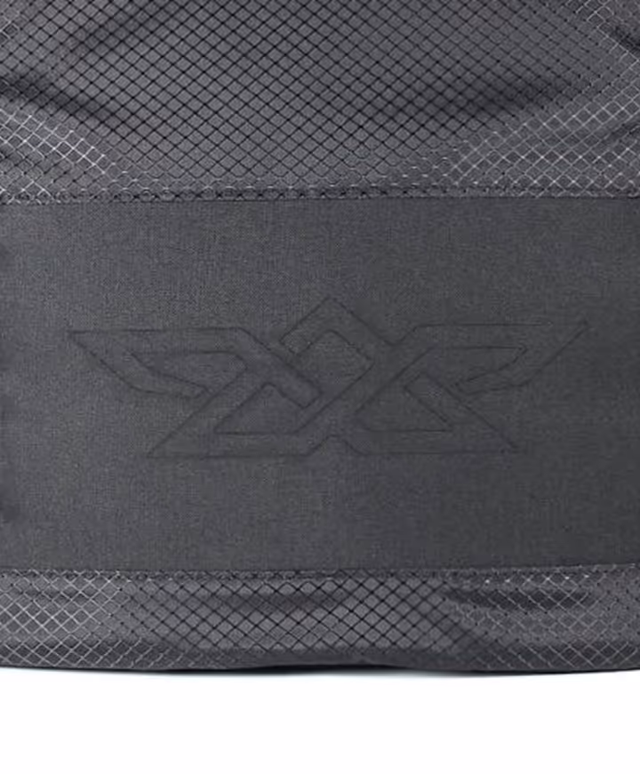 Close-up of black fabric with a geometric embossed logo and mesh texture on top and bottom edges.