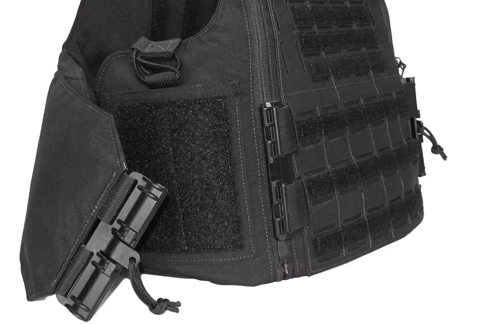 Close-up of a black tactical vest with Velcro patches and buckle fasteners on a white background.