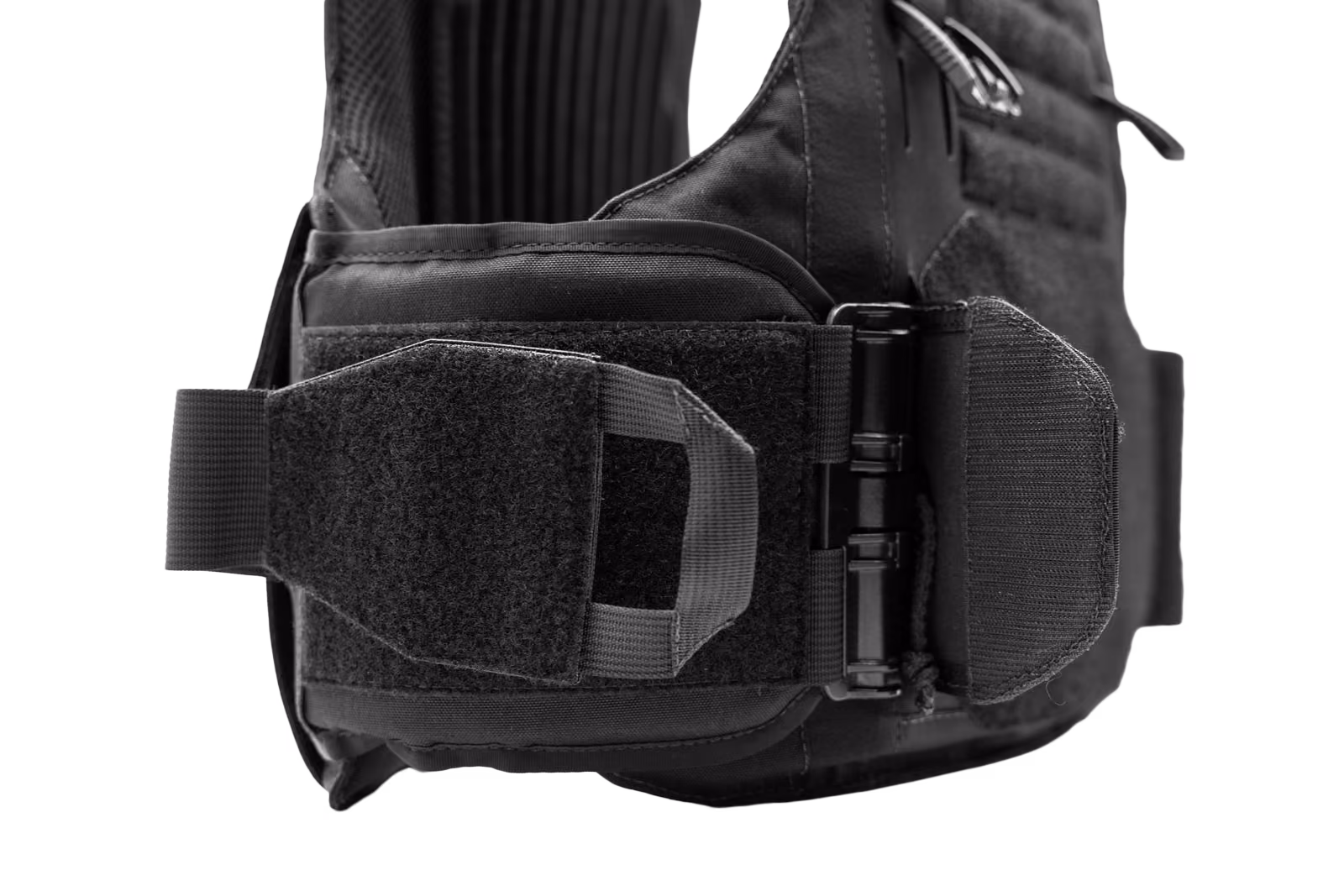Close-up of a black tactical vest strap with hook and loop fastener and a quick-release buckle.