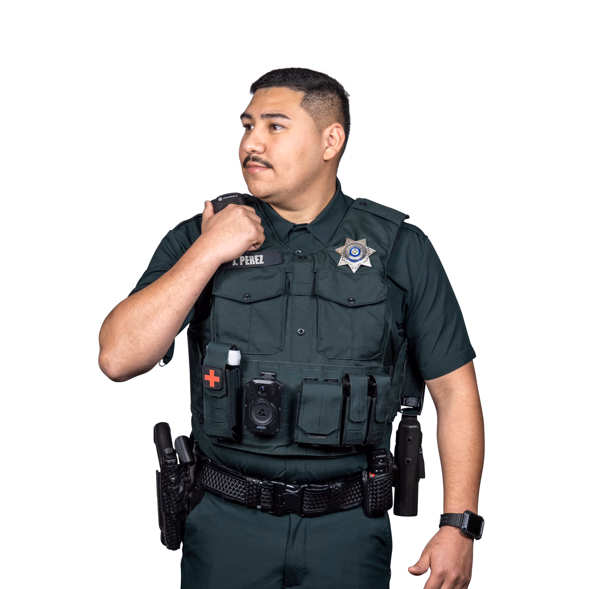 Uniformed police officer with radio, body camera, and medical kit on tactical vest looking to the side.