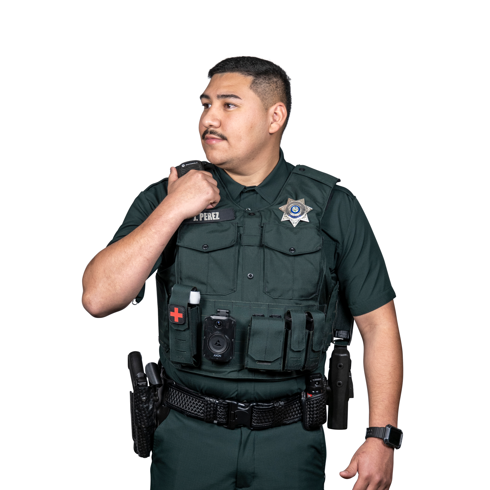 Uniformed police officer with radio, body camera, and medical kit on tactical vest looking to the side.