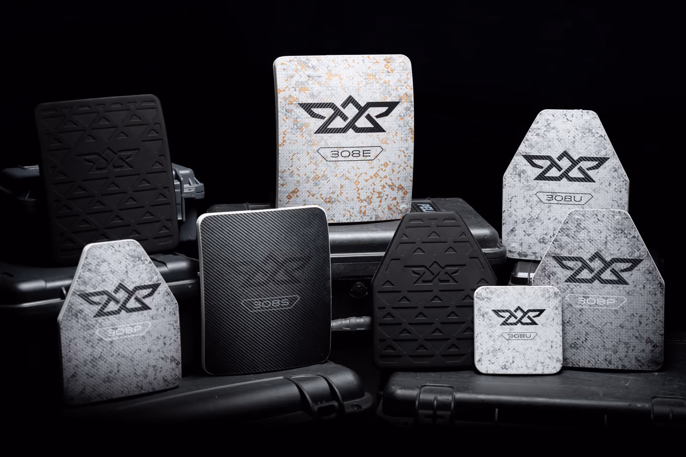 Various black and white shooting target plates with markings arranged on black cases.