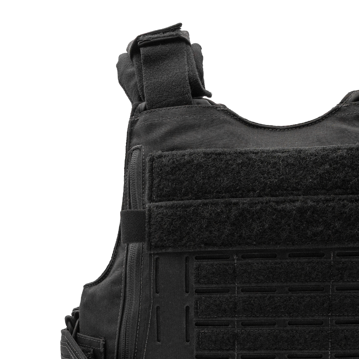 Close-up of black tactical vest with velcro straps and attachment points on front panel.