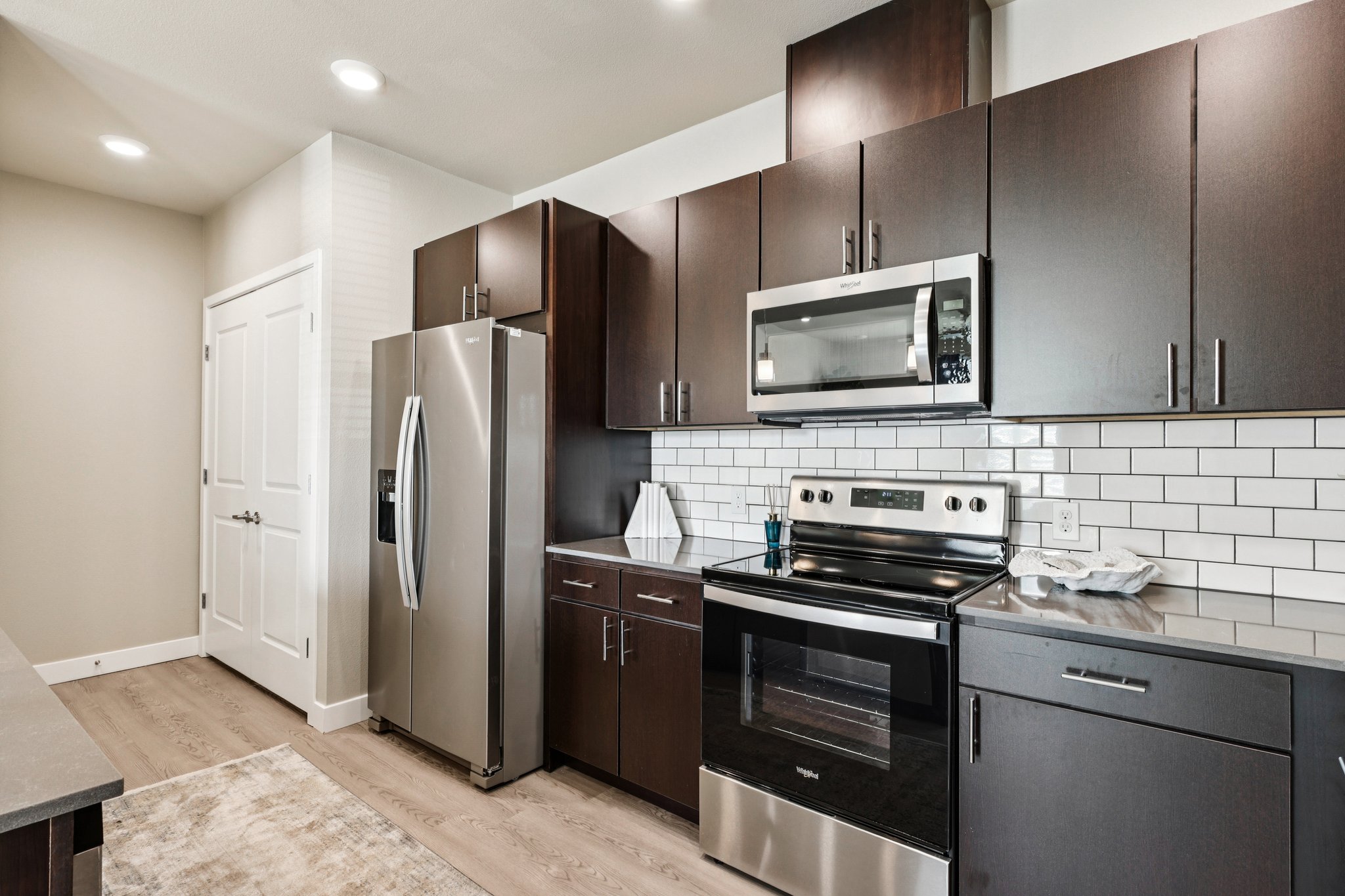 Luxury Kitchen with brown cabinets l 1 & 2-Bedroom Homes