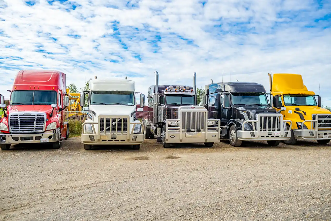 Fleet maintenance with multiple heavy-duty semi trucks parked and ready for service at a repair facility.