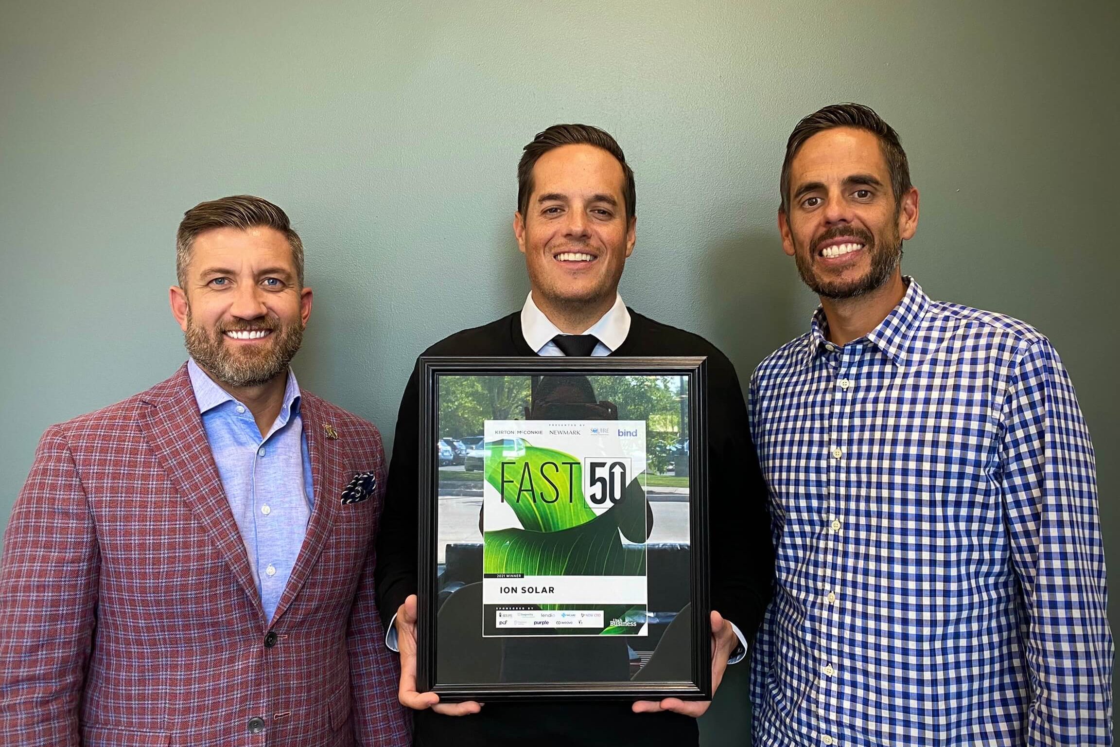 From Left to Right: Jeremy Call, Dave Rasmussen, Matt Rasmussen holding the 2021 Fast50 Award.