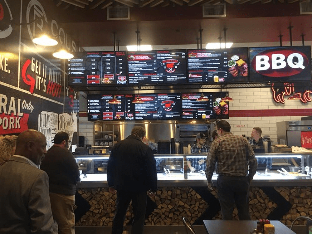 digital menu boards at a barbecue restaurant