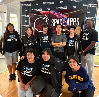 A group of 9 students with Code Your Dreams shirts in front of a banner reading "SPACE APPS"