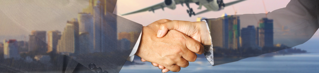 Two people shaking hands with a city skyline and airplane in the background.