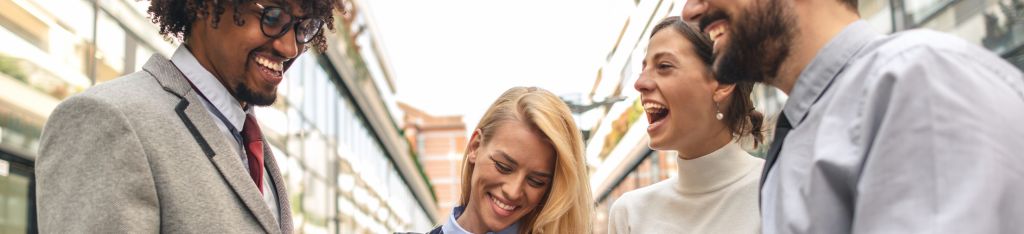 Mini shopping cart with green leaves inside, surrounded by wooden hangers on a green background.