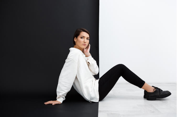 Young girl model in a white shirt and black pants