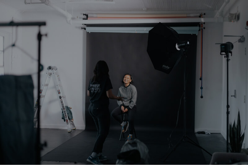 Girl sitting in front of a photographer