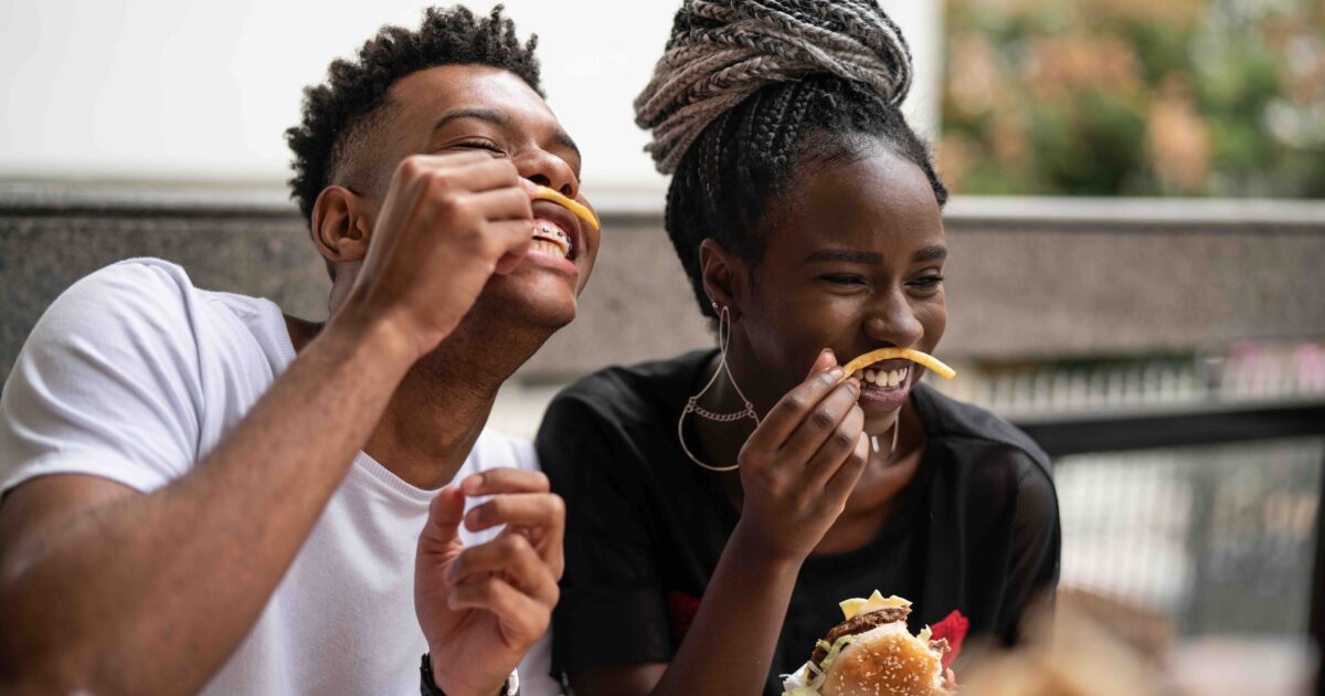 2 people eating french fries
