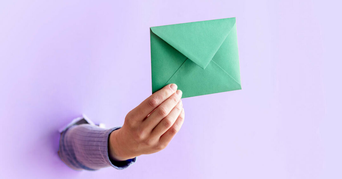Hand holding an envelope