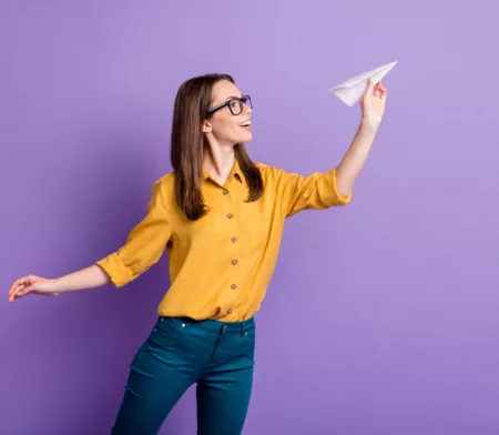 Woman throwing a paper plane