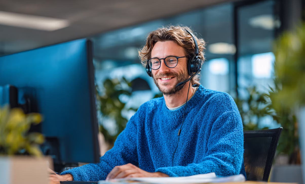 Uberall support agent wearing a headset helping a customer