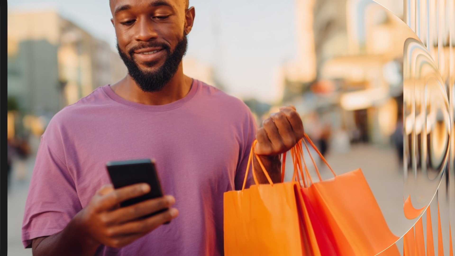 Smiling man checking his smartphone while carrying orange shopping bags on a city street