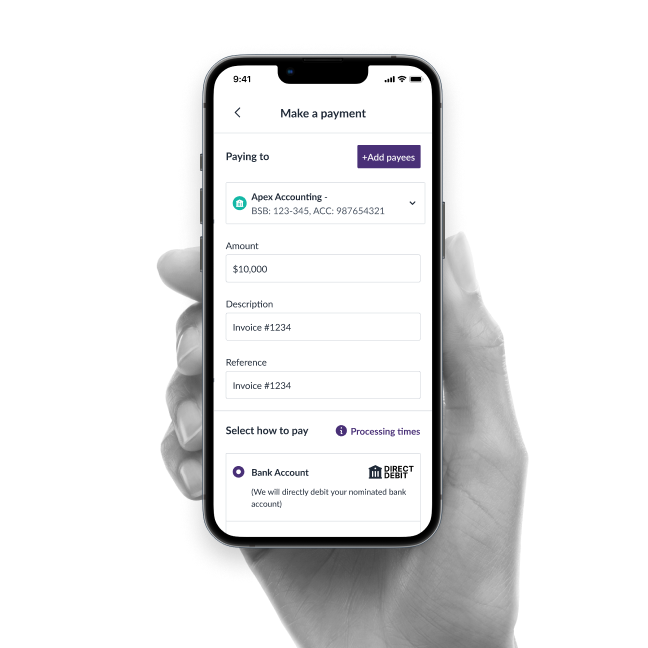Hand holding phone showing a payment app screen with payee, amount, description, and payment method fields.