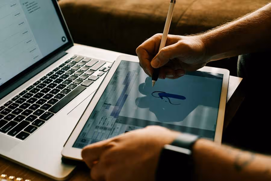 Close up shot of a man designing a system for fire safety on a tablet.