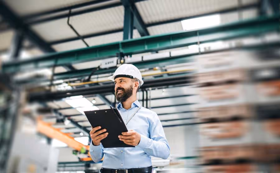 A professional inspector conducting an evaluation for fire safety compliance, wearing a hard hat.