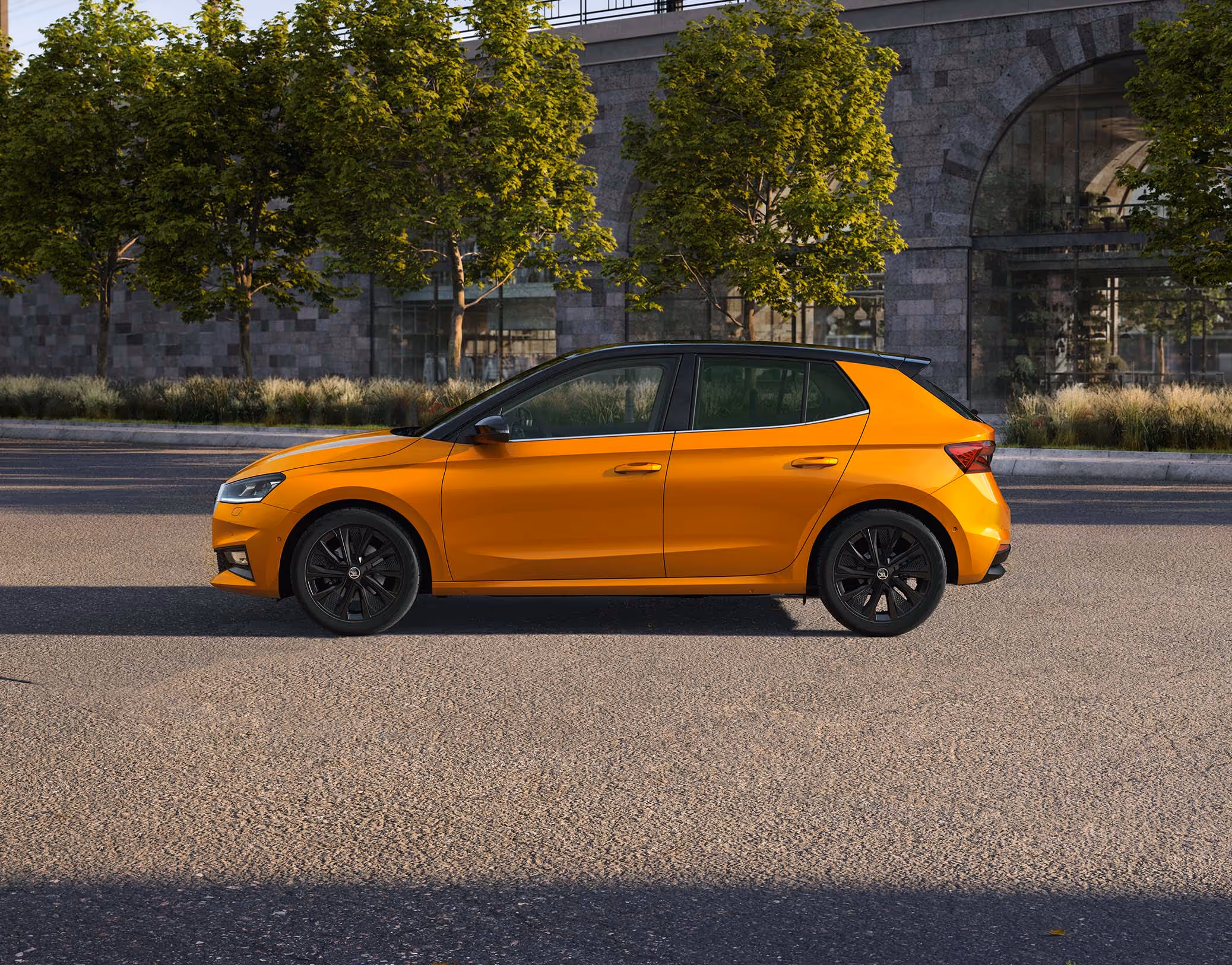 Schräge Heckansicht eines Škoda Elroq in der Farbe Timiano-Grün vor einem grünem Studiohintergrund. Die Rückleuchten und der prominente Škoda Schriftzug am Heck sind deutlich zu sehen.