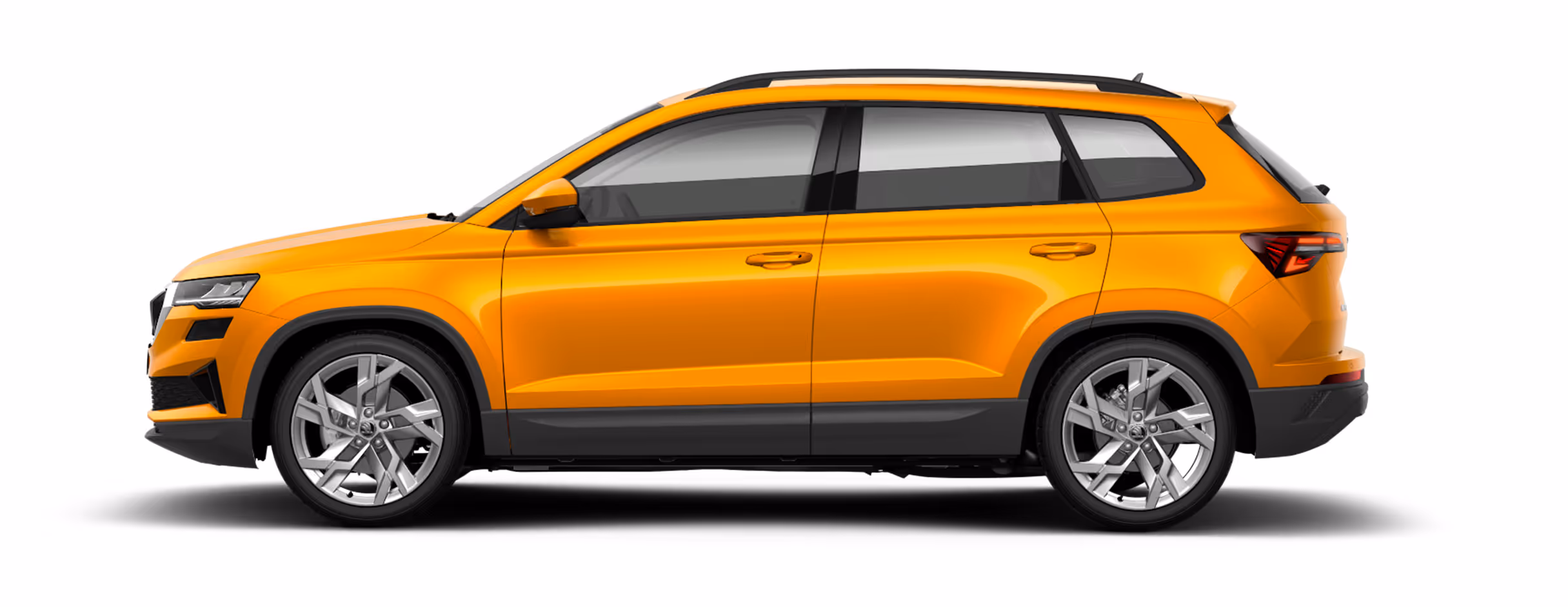 Seitenansicht eines freigestellten Škoda Karoq in der Lackierung Phoenix-Orange Metallic mit 19 Zoll Leichtmetallfelgen “Sagitarius".
