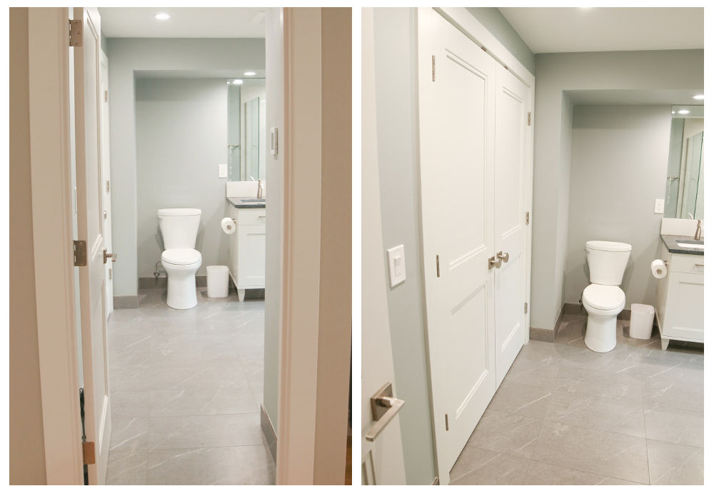 Modern bathroom with a white toilet, white vanity with gray countertop, large mirror, and gray tiled floor.