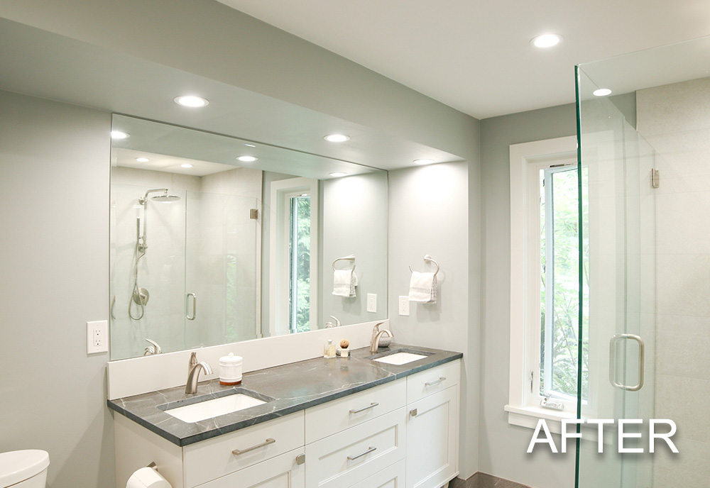 Modern bathroom with double sink white vanity, large mirror, glass shower enclosure, and a window.