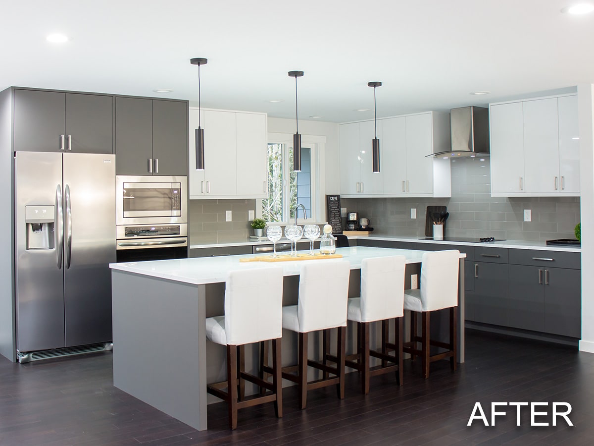 Modern kitchen with white and gray cabinets, stainless steel appliances, and a large island with four white upholstered chairs.