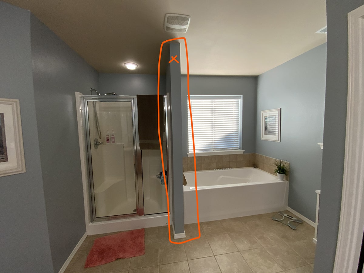 Before - large master bathroom with a 4-foot wall separated the shower enclosure