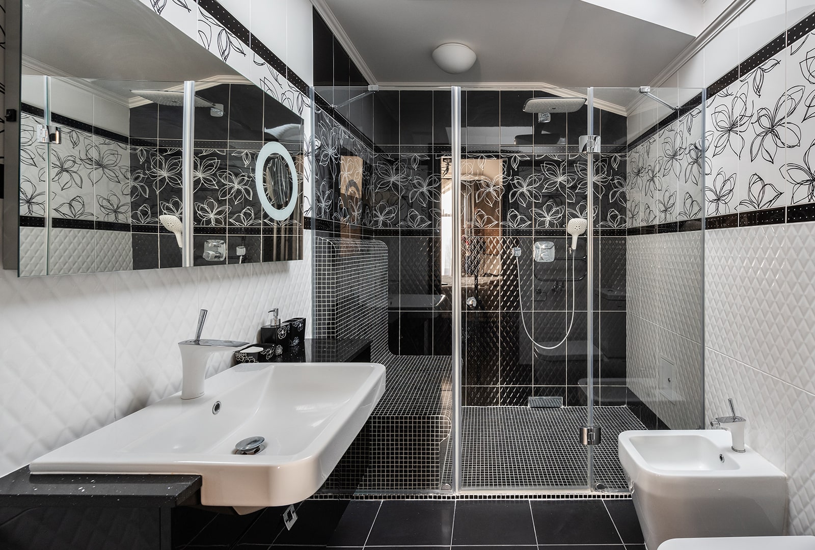 A monochromatic bathroom with different tile patterns