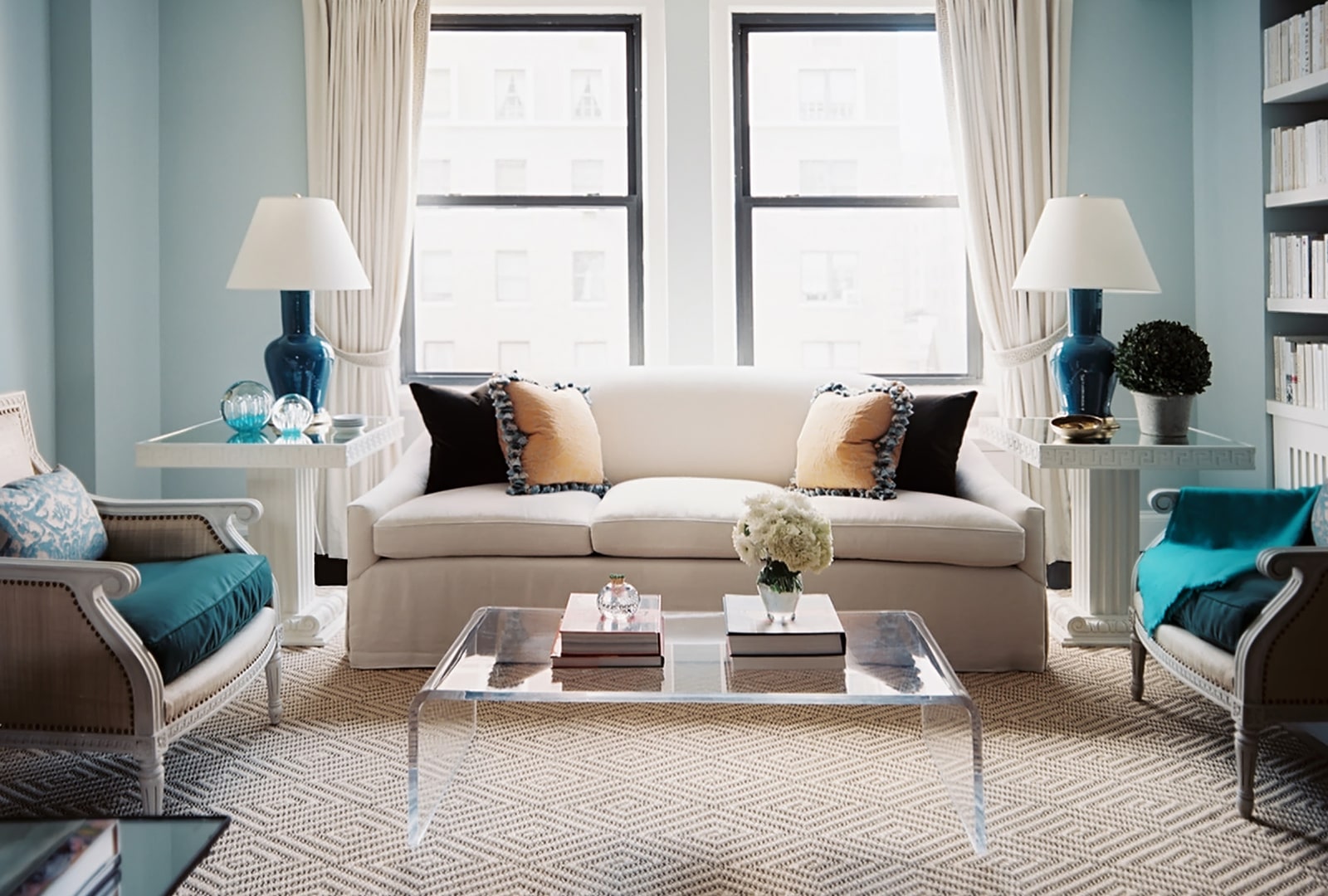 Elegant White sofa with clear acrylic table at the center.