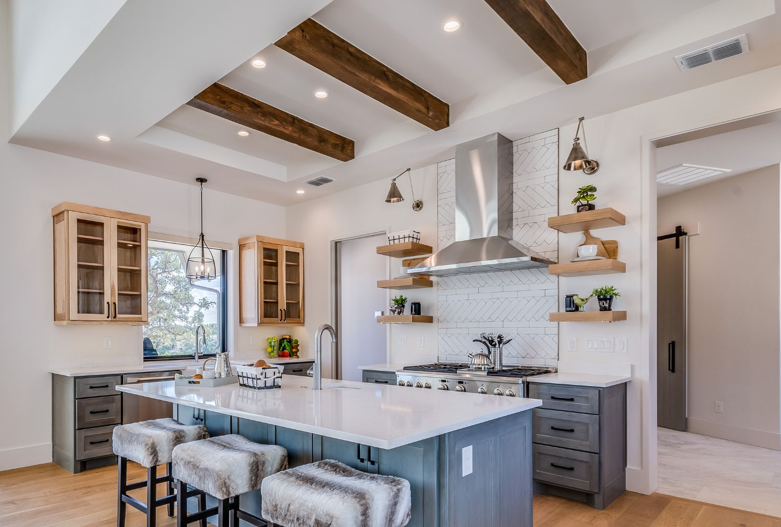 Three wooden beams accentuate ceiling in kitchen