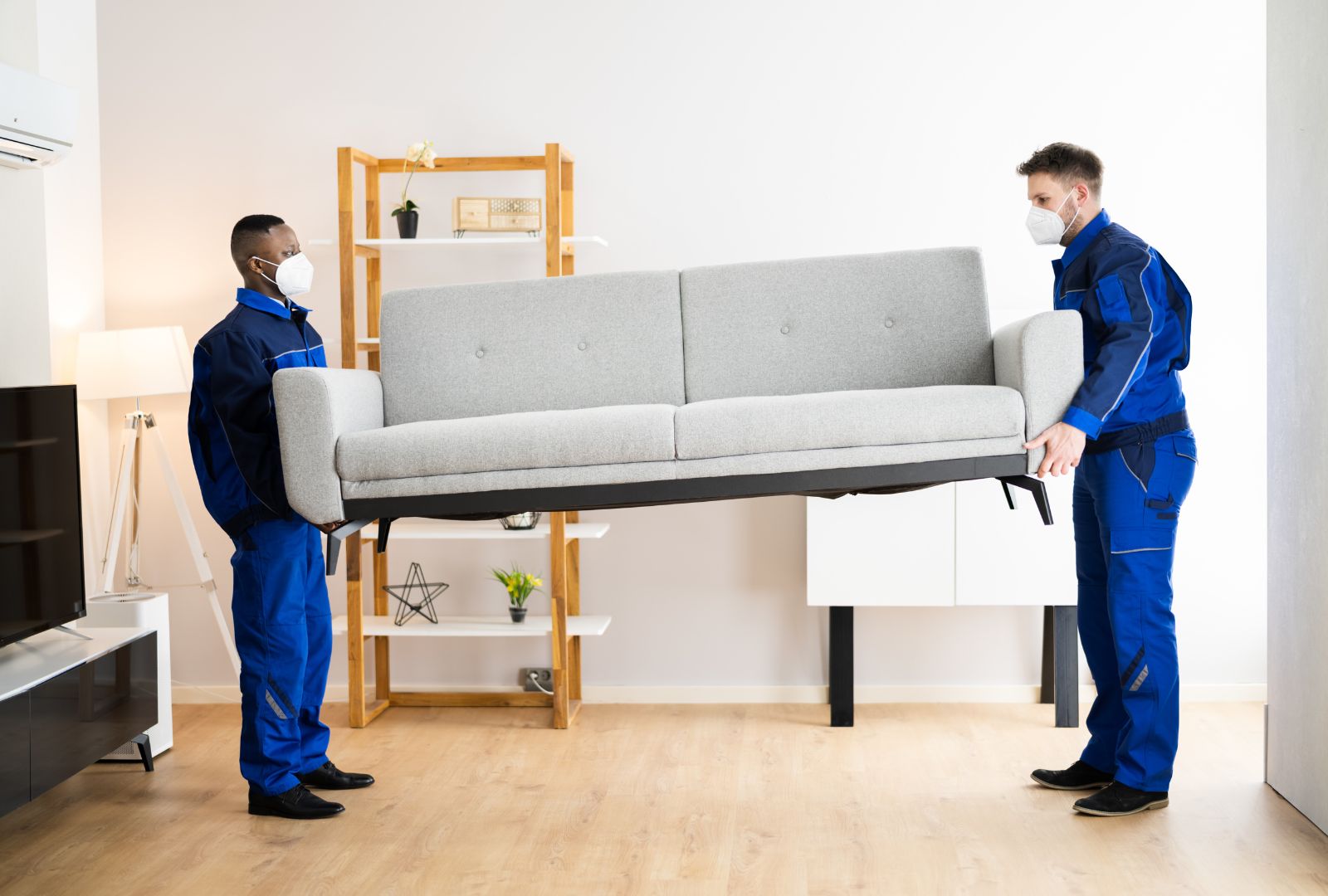 two male movers placing the sofa