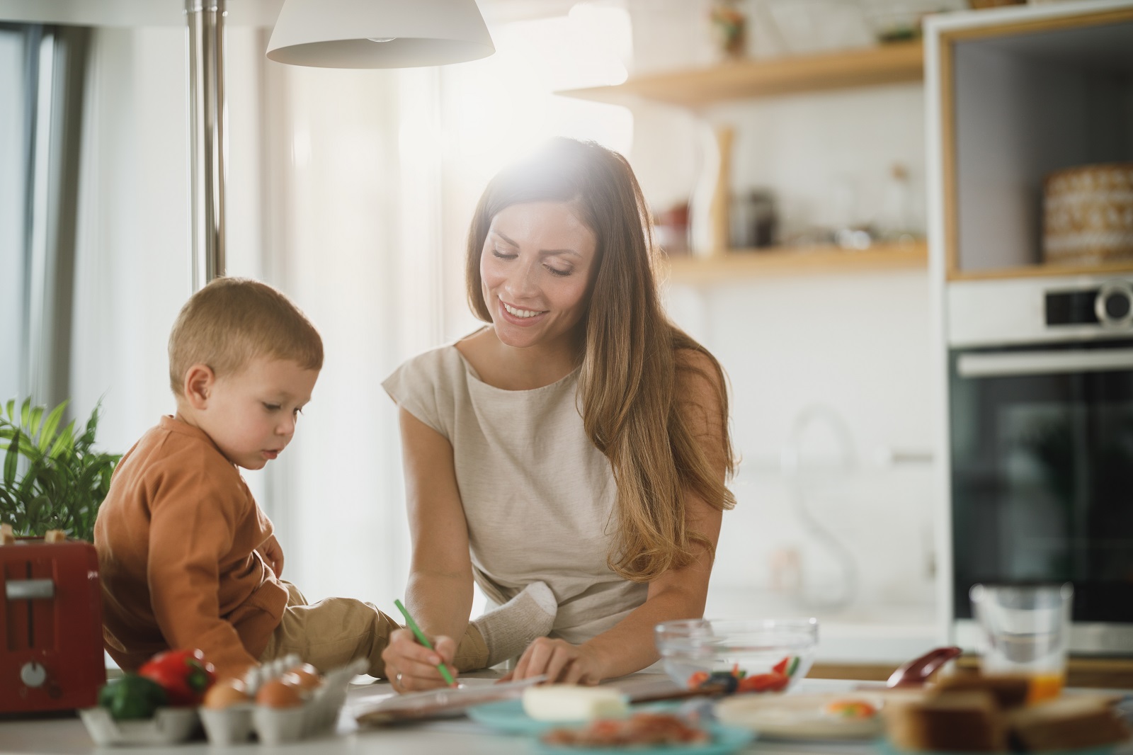 A mom and a son on a kitchen counter.