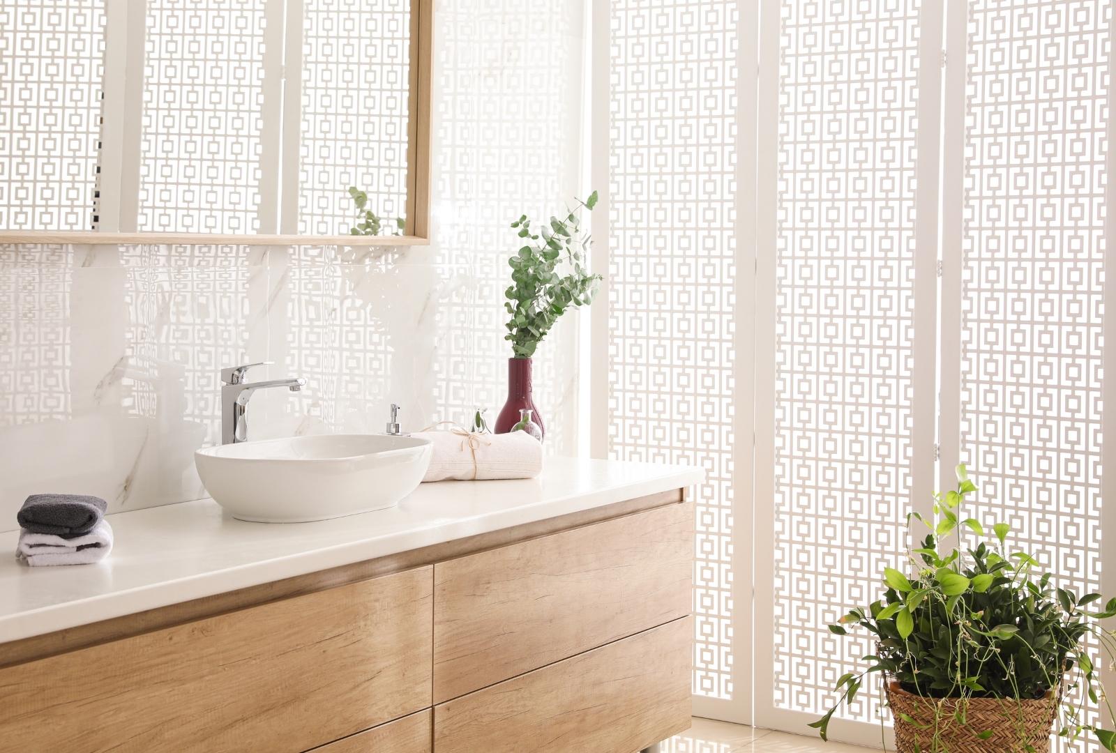 Stylish Bathroom Interior with Countertop, Mirror and Plants.