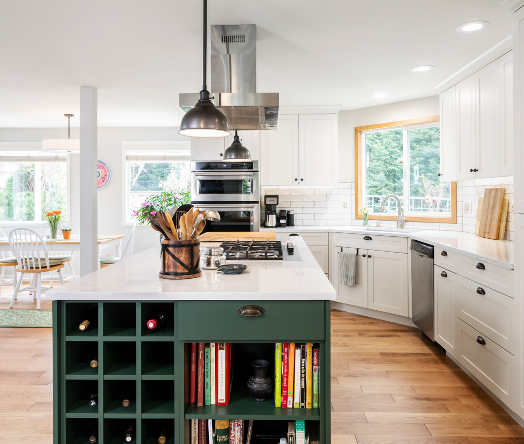 Close-up of green kitchen island wine rack with stored bottles, showcasing modern craftsmanship and custom cabinetry details in a transitional kitchen remodel.