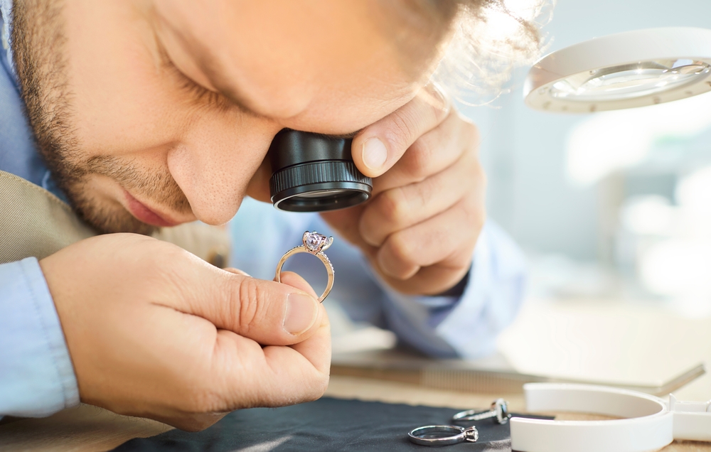 Professional jeweler doing visual examination of jewelry ring