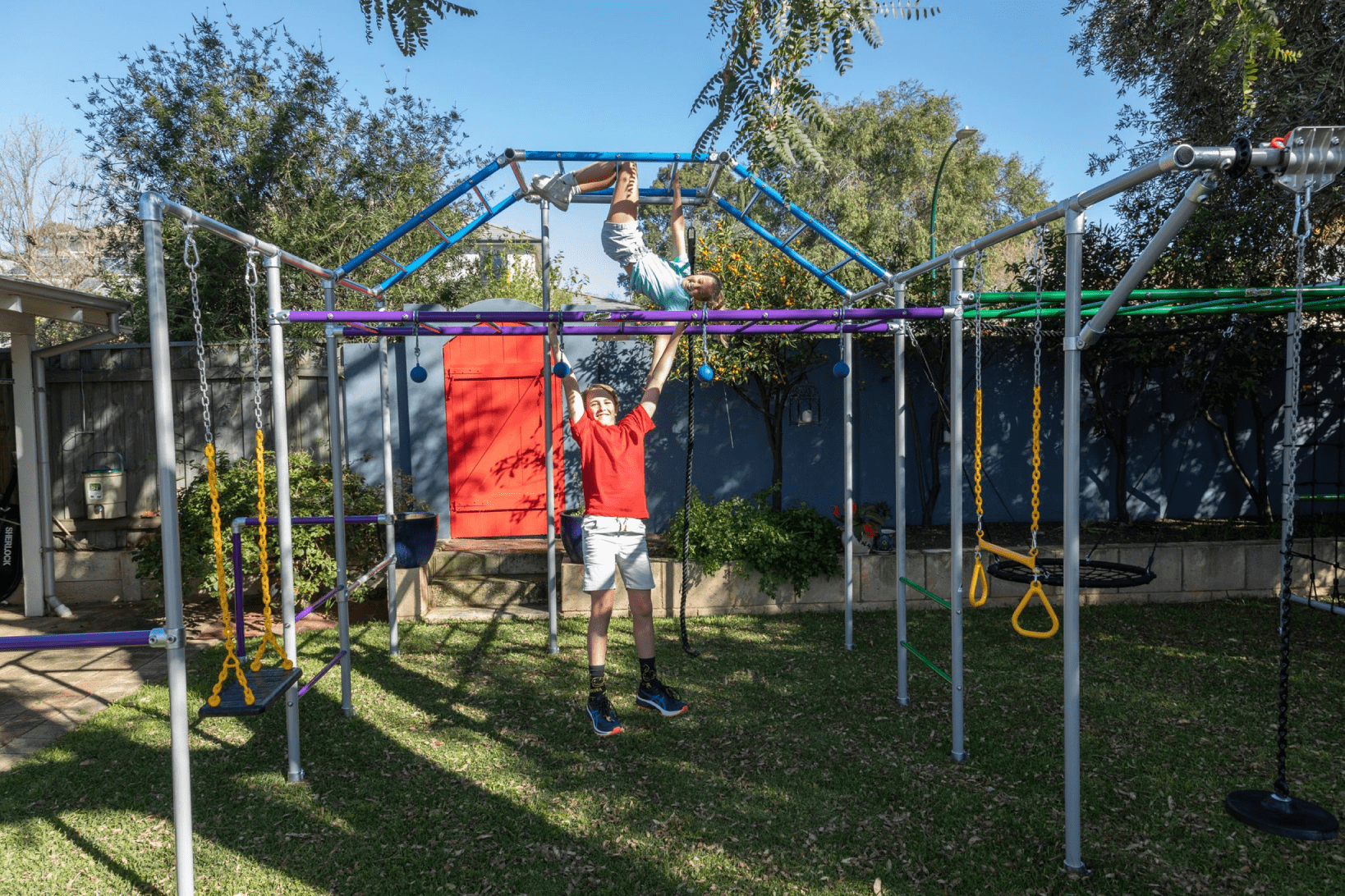 Children playing on monkey bars in a playground.